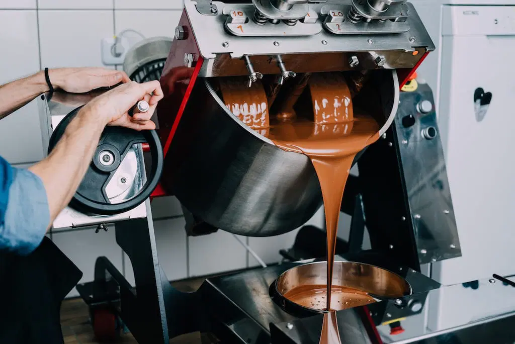 Chocolate flowing from the AHERZ bean-to-bar melanger.
